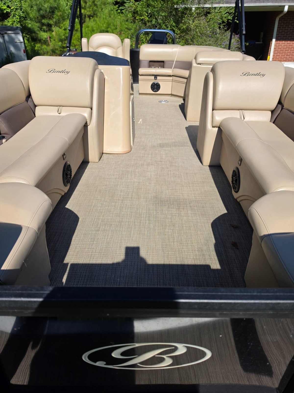 The stern view forward along the deck, with cushioned bench seats and speakers built into the seat bases on both sides.
